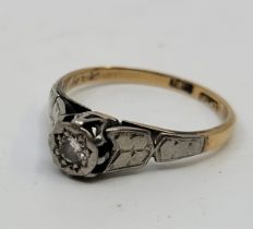 An 18ct. gold and platinum diamond solitaire ring, illusion set round brilliant cut diamond to