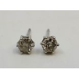 A pair of unmarked white metal diamond stud earrings, each set round brilliant cut diamond (ETDW 0.