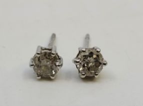 A pair of unmarked white metal diamond stud earrings, each set round brilliant cut diamond (ETDW 0.