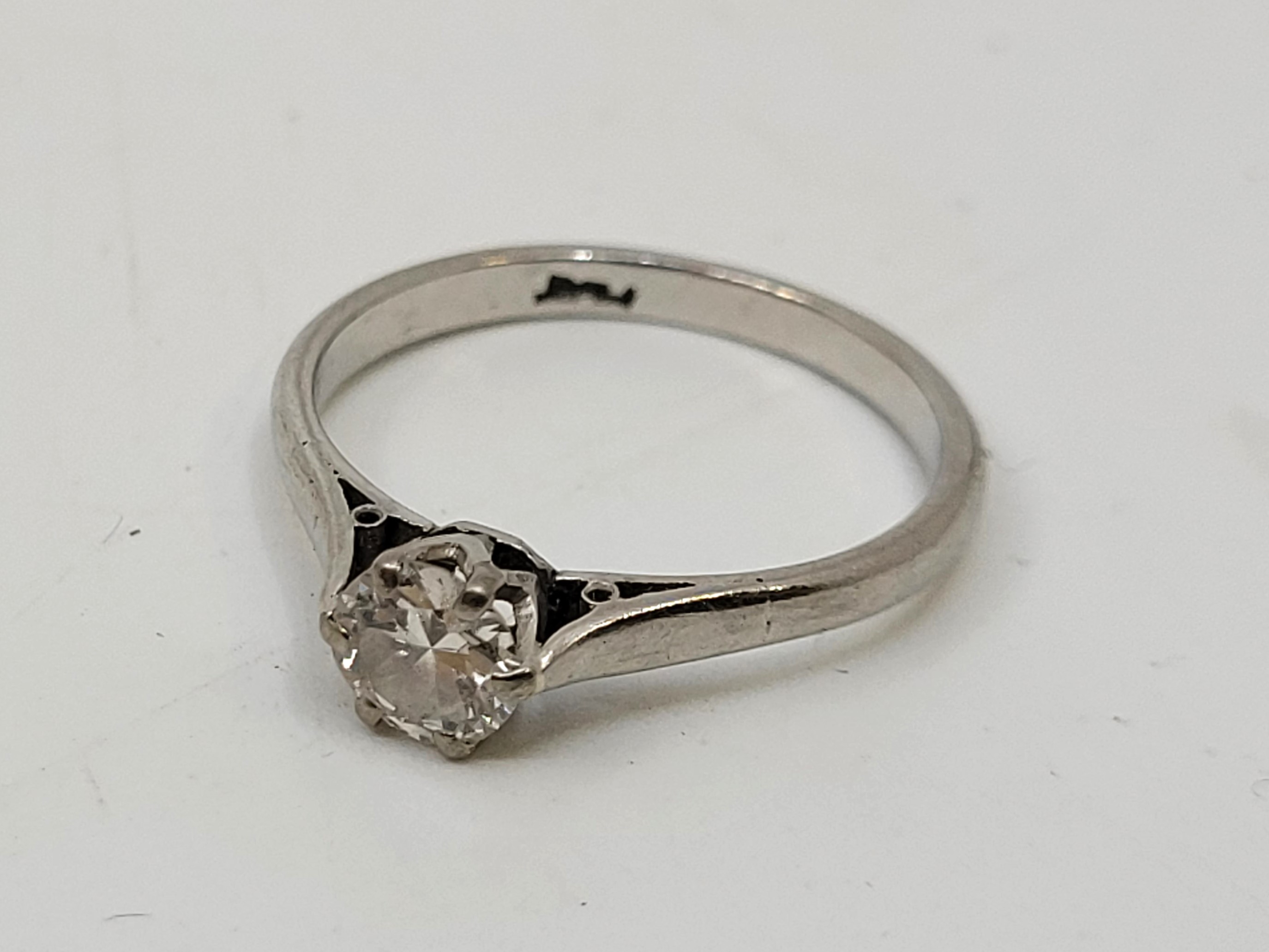 A platinum diamond solitaire ring, claw set round brilliant cut diamond (EDW 0.40 carats), size UK
