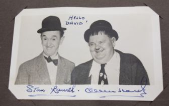 Autographs. An album of signed photographic publicity cards, c. 1950s, to include Laurel & Hardy;