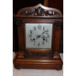 Large Mahogany cased mantel clock with carved column and floral details to front, chiming facility &