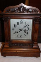 Large Mahogany cased mantel clock with carved column and floral details to front, chiming facility &