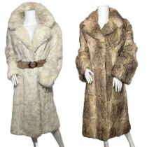 Two vintage coney fur coats, one in off white with a suede belt closure along with furrier hooks.