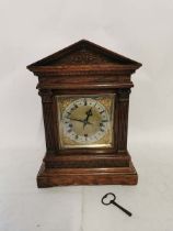 Circa 1900 brass faced and oak cased wind up chiming mantel clock, with pendulum and key. 43cm high,