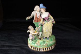 A German porcelain figure group in 18th century style modelled as a gallant and his female companion
