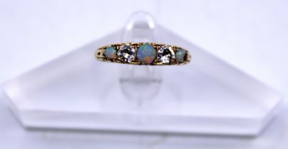 Vintage 18ct Yellow Gold Opal And Diamond Five Stone ring.  The ring contains three Opals and two