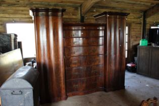A large Victorian mahogany triple bedroom piece consisting of serpentine fronted drawers between two
