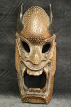 A carved dragon demon mask, possibly Indonesian, 54.5cm high