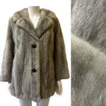 A silver blue mink jacket, late 1960s with half back belt and deep lapels. Fastens with furrier