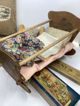 Antique dolls toys; to include  cot (1918) c 12” long and a set of late Victorian complete picture