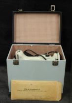 A Singer Featherweight model 221 portable electric sewing machine, cased and with instructions and