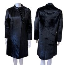 An elegant late 1950s fur coat in silky black seal, with spherical glass buttons asymmetrically