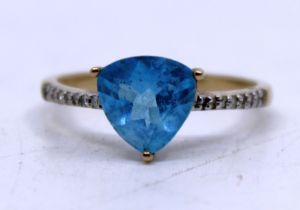 9ct Yellow Gold Topaz and Diamond ring.  The Blue Trilliant Cut Topaz measures approx. 8mm x 8mm.