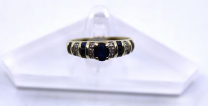 14ct Yellow Gold Sapphire & Diamond dress ring.  There is an Oval Brilliant Cut Sapphire in the