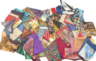 A group of vintage scarves and squares including silks, rayons and other fabrics along with 3