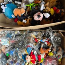 A collection of 80s-00s McDonalds and Kinder Egg toys alongside a large box of plastic dinosaur