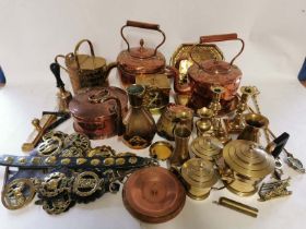 A quantity of brass and copper ware to include kettles, bell, watering can, horse brasses, horses