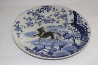 A Large Meiji Period Japanese Blue and white hand painted Imari Porcelain Wall Charger.