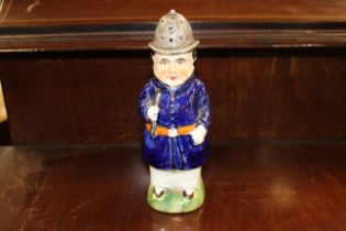 A late 19th century Staffordshire pottery policeman pepper pot. (1)