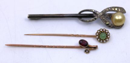 Two Gold Coloured Stick Pins and an Unmarked White Metal pin badge.  One of the Stick Pins is an