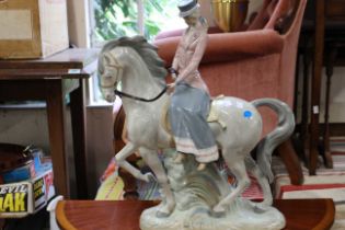 A Large "Rex" porcelain figure of a lady riding side saddle on a grey horse. (1)