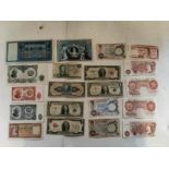 A collection of assorted circulated bank notes to include USA dollars, UK Shillings, German notes