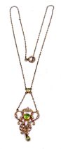An Edwardian Art Nouveau Gold, Peridot & Split Pearl Pendant Necklace. A Round Old Cut Peridot to