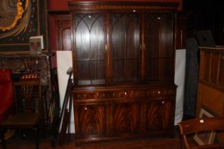 A 20th century flame mahogany triple cabinet with glazed doors over drawers and cupboards. 145cm