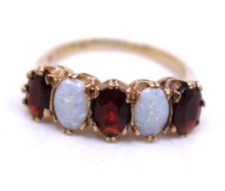 9ct Yellow Gold Opal & Garnet Five Stone ring.  The ring is hallmarked "9" for 9ct Gold. The ring