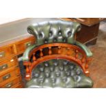 A Captains swivel arm chair with green leather buttoned upholstery. (1)