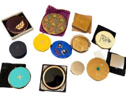 A collection of vintage compacts to include a large purple and gilt kigu compact with peach