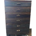 A small chest of stained brown wood drawers