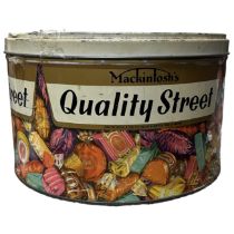 A large collection of vintage buttons in a vintage quality street tin including many full sets on