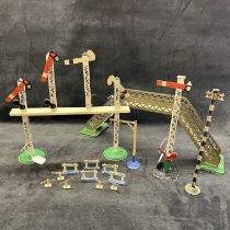 A collection of vintage Hornby railway signals to include a 30s single arm signal, a quad arm gantry