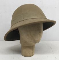 A WW2 era British Wolseley Pattern pith helmet, dated 1942 and broad arrow marked to the leather