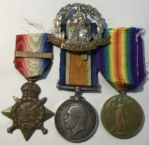 A WW1 1914 Star and Mons Clasp trio, and cap badge awarded to 3-7220 Pte Walter Harrison of the