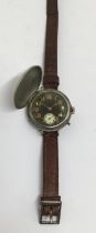 A WW1 era trench wristwatch, with original leather strap, dated Christmas Day 1916. Nickel casing,