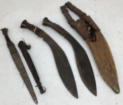 Two mid 20th century Nepalese Kukri knives, one in a leather sheath with military style frog