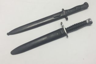 A type 45 1903 Siamese Mauser bayonet with scabbard. Wooden slab grips, with blued steel pommel