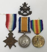 A 1915 Star trio and original period cap badge, awarded to 12576 Sjt Richard Evans of the North