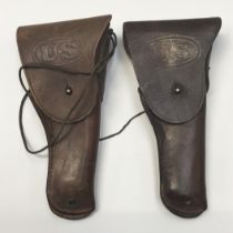 2 examples of the WW2 United States leather holsters for the M1911 Colt Pistol. One marked for