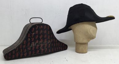 A good quality WW2 era Royal Navy officer’s Bi-corn hat, with toleware box. The bi-corn is of