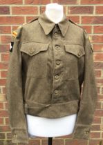A late WW2 era 1940 pattern, 1945 dated British Army Battle Dress Blouse. Fitted with cloth shoulder