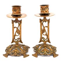 A pair of Arts & Crafts copper candlesticks, by William Tonks and Sons, cast scrolled and foliate
