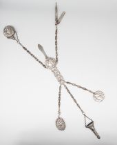An early 20th century Art Nouveau silver plated (EPNS) chatelaine, having stylised female portrait