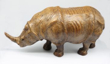 A 20th Century leather Rhino, with glass eyes. Length approx 52cm, height approx 24cm. Condition: