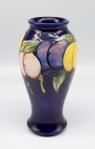 A Moorcroft Pottery vase in the Wisteria design, impressed mark W. Moorcroft. Height approx 19cm. No