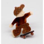 Lea Stein - a 'Skater' brooch in chequered cap and trousers, amber effect t-shirt, on skateboard,
