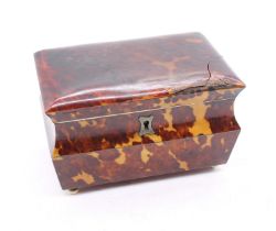 A late Georgian tortoiseshell tea caddy with four bun feet, the body of curved form with hinged